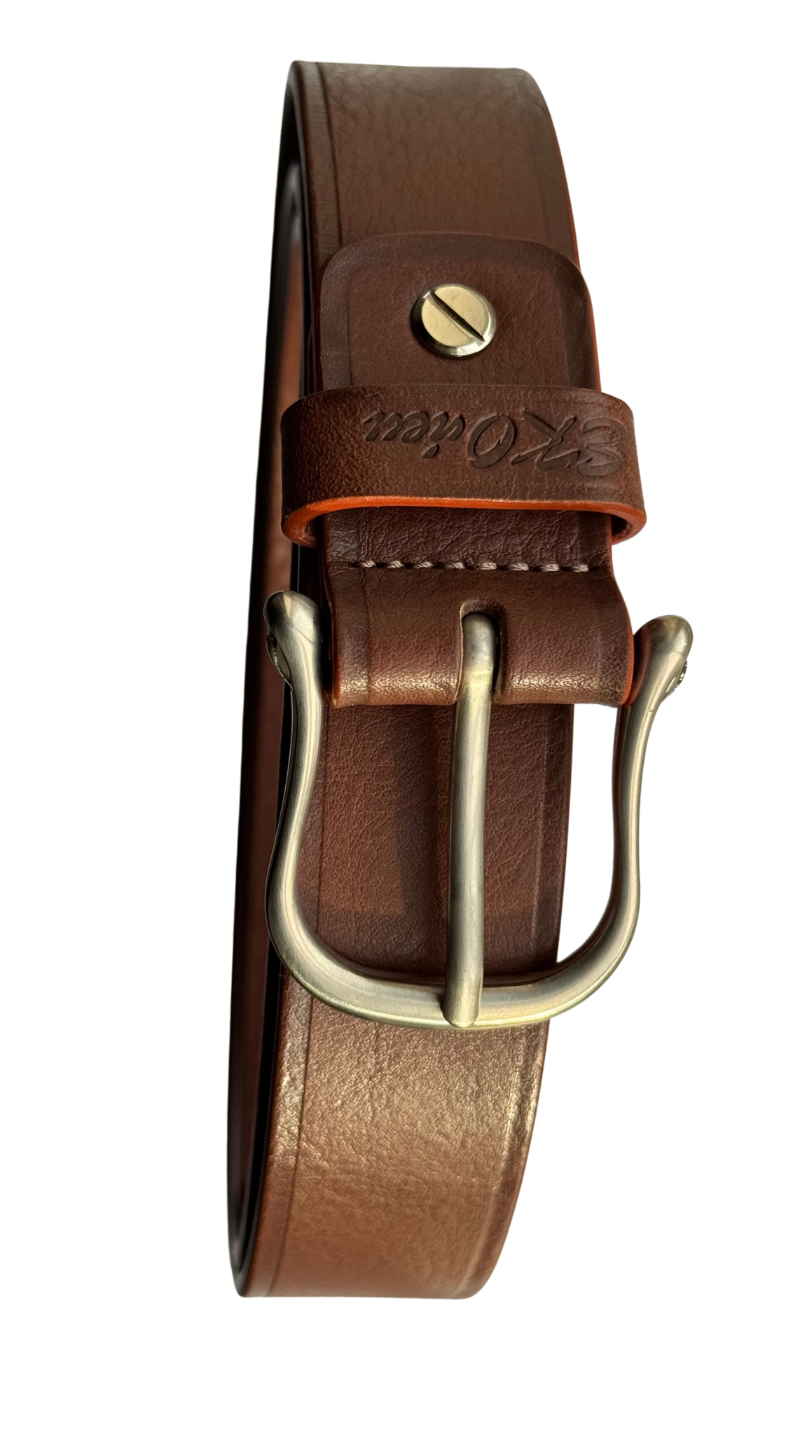 Brown Daniela leather belt showing its metal buckle and prong, embossed leather keeper, screw attachment, and stitching near the buckle.