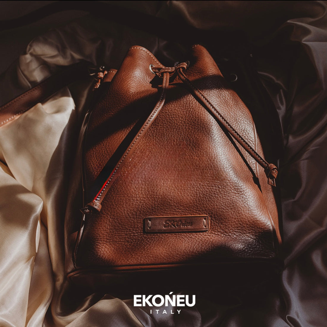 Full-grain Italian leather bucket bag by EKOńeu showing natural grain texture and patina