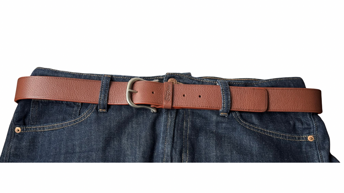 Close-up of brown Lazzaro leather belt showing leather grain, adjustment holes, and reddish finished edges.